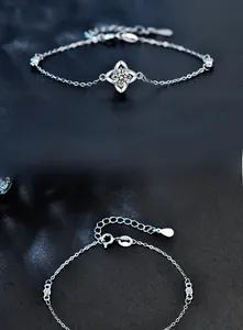 Macro detail of Moissanite clover bracelet with 925 sterling silver chain and clasp