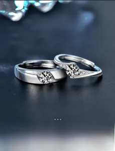 Macro shot of S925 sterling silver couple rings with moissanite stones on a dark background