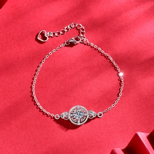 925 silver bracelet with moissanite coin pendant on red silk festive background