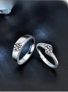 Macro shot of S925 sterling silver couple rings with moissanite stones on starry background