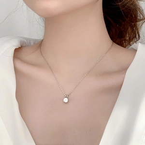Elegant 925 sterling silver moissanite necklace with four-claw pendant on a female neck