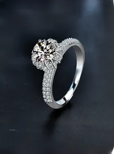 Macro shot of sparkling round cut moissanite ring with petal halo and paved band