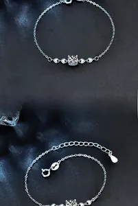 Close-up of 925 sterling silver bracelet featuring heart design and moissanite stone