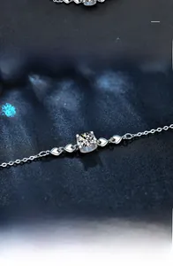 Close-up of S925 sterling silver bracelet with heart accents and moissanite stone