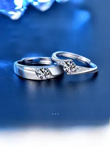 Close-up of S925 sterling silver couple rings with round brilliant-cut moissanite stones