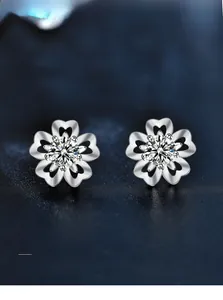 Close-up of 925 silver cherry blossom earrings with 3EX cut moissanite and heart petals