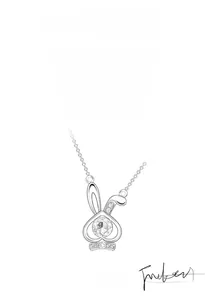 Macro detail of silver rabbit pendant featuring sparkling moissanite and bow accent