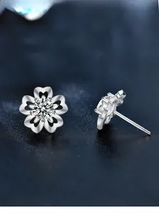Macro view of 925 silver cherry blossom earrings with moissanite and heart petals