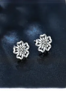 Close-up of S925 silver cherry blossom studs with moissanite and hollow heart petals