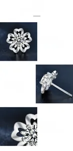 Macro view of cherry blossom moissanite studs with five-petal silver claw setting