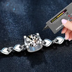 925 sterling silver heart bracelet with a 0.5ct moissanite center on a blue background