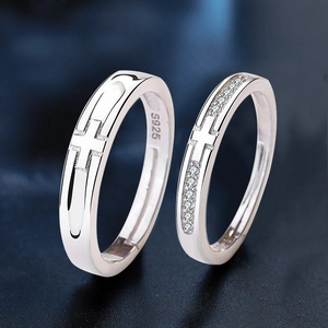 S925 sterling silver couple rings with cross design and zircon stones on a dark background