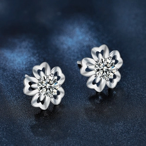 S925 sterling silver cherry blossom stud earrings with moissanite center on star background