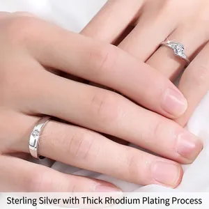 S925 sterling silver couple rings with moissanite diamonds worn on hands on white silk