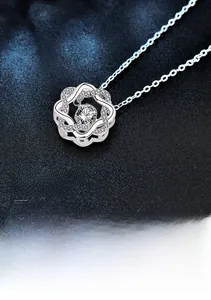 Macro view of S925 sterling silver flower pendant featuring a shimmering central diamond