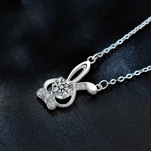 Moissanite rabbit 925 sterling silver necklace with sparkling main stone on leather background