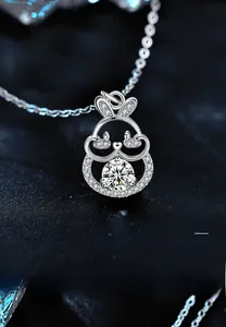 Macro shot of 925 silver rabbit pendant with moissanite stones on black background