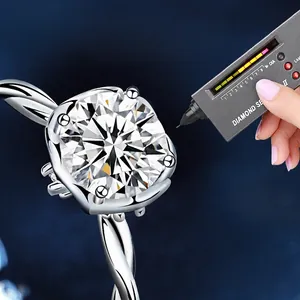 Moissanite ring with twisted band and four-prong setting tested by diamond tester pen