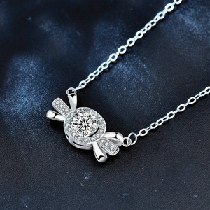 Moissanite candy pendant necklace in 925 sterling silver on a deep blue textured background