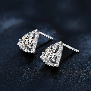 Macro shot of sterling silver triangle earrings with a sparkling moissanite pear drop stone
