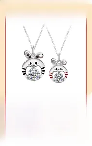 Detail of couple rabbit pendants with colorful stripes and sparkling round cut moissanite