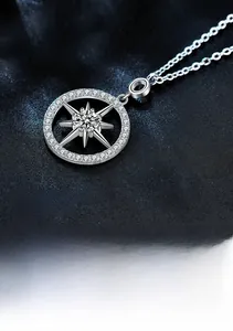 Close-up detail of S925 sterling silver starburst pendant with sparkling moissanite stones