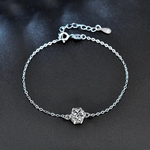 Macro detail of S925 sterling silver bracelet showing six-prong setting and round gemstone