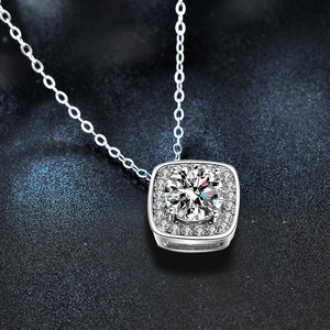 Macro shot of a 925 sterling silver square halo necklace with a brilliant round centerpiece