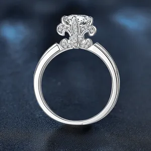 Macro side view of silver fleur-de-lis ring with large sparkling center diamond stone