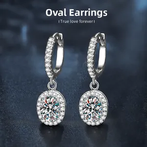 Macro shot of 925 sterling silver oval moissanite earrings with halo stones