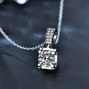 Macro view of four-prong moissanite pendant with micro-pave diamonds on silver bale