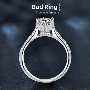 Macro shot of Moissanite sterling silver ring featuring a floral bud setting detail