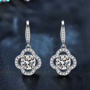 Detailed view of silver clover earrings with sparkling pavé crystals and horse-eye hooks