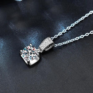 Close-up of S925 sterling silver mark and round moissanite pendant with four-prong setting