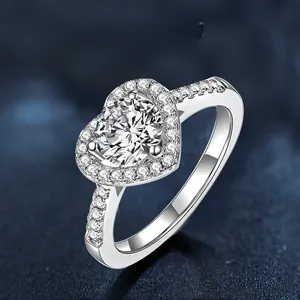 Macro detail of heart-shaped moissanite ring in 925 silver with side accent diamonds