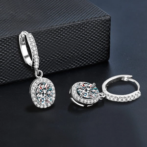 Macro detail of 925 silver oval halo earrings with moissanite pave setting