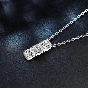 Macro shot of 925 silver necklace with three radiant moissanite stones on black leather