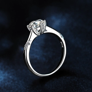 Detailed view of six-prong classic moissanite ring with S925 silver stamp on inner band