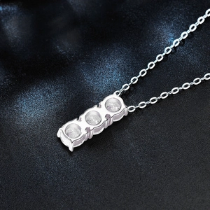 Three-stone 925 sterling silver necklace featuring brilliant round moissanite pendants
