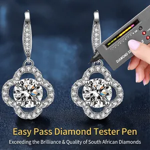 Sterling silver four-leaf clover earrings with brilliant diamonds and tester pen scene