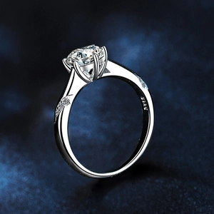 Classic 925 sterling silver ring with a six-prong moissanite stone on blue background