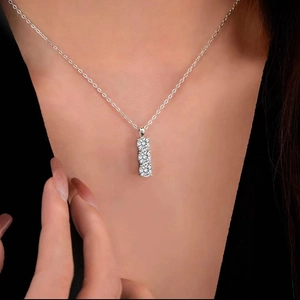 Elegant 925 sterling silver necklace featuring three vertical moissanite stones on model