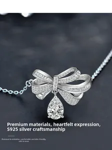 Macro detail of S925 sterling silver bow pendant with a pear-shaped drop stone