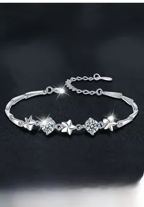 Macro detail of S925 sterling silver four-leaf clover bracelet featuring Moissanite stones