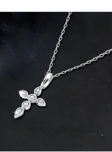 Macro detail of S925 silver cross pendant with shimmering moissanite stones and O-chain