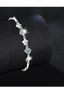 Macro detail of silver clover bracelet with stones and protective plating finish