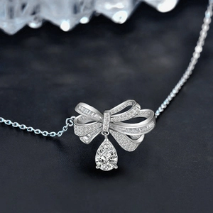 925 silver necklace featuring a bow pendant with drop-shaped moissanite and tassel design
