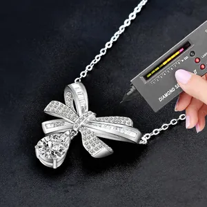 S925 silver bow necklace with pear-cut Moissanite pendant passing diamond tester tool