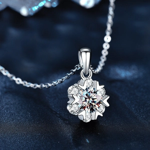 S925 sterling silver snowflake pendant necklace with Moissanite stones on a blue background
