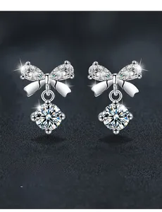 Macro shot of S925 sterling silver bow earrings with 3EX cut moissanite dangling stones